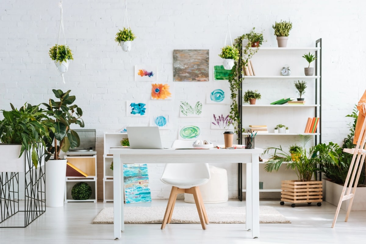 Why You’ll Love Upgrading to a Contemporary Desk Chair This Year 1 Stylish office interior with a contemporary desk chair placed in a light, airy room decorated with hanging plants and shelves.