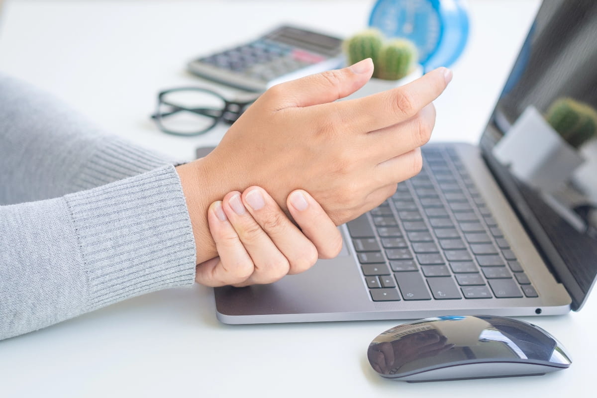 Wrist discomfort from poor keyboard and mouse positioning.
