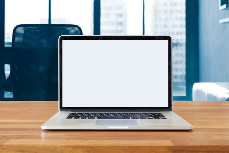A laptop on a desk, illustrating the need for the best computer chairs.