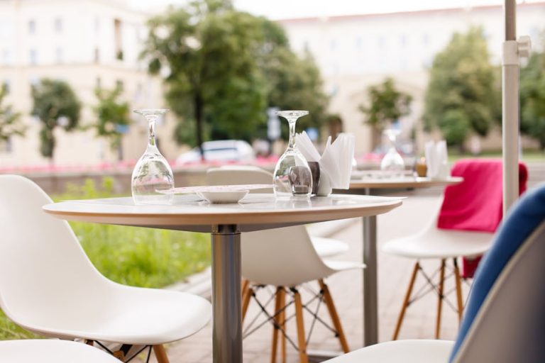 A street cafe with outdoor seating and tables.