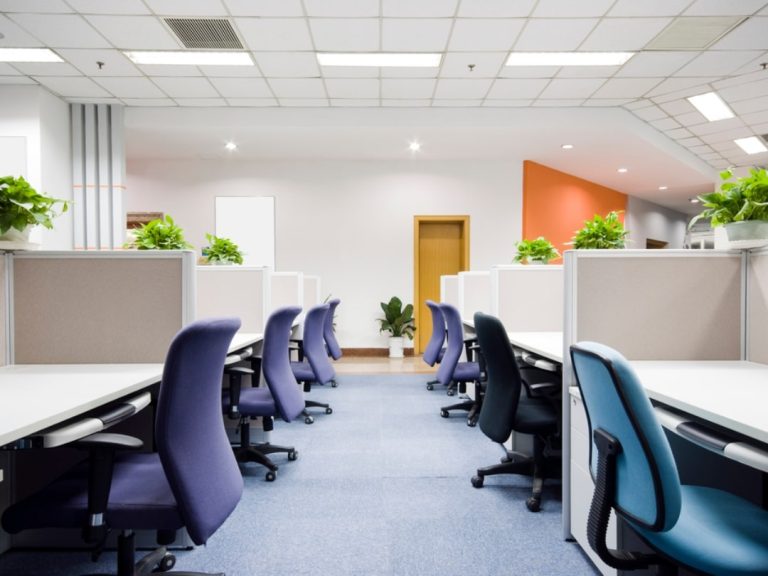Office desks with purple and blue gas lift chairs.