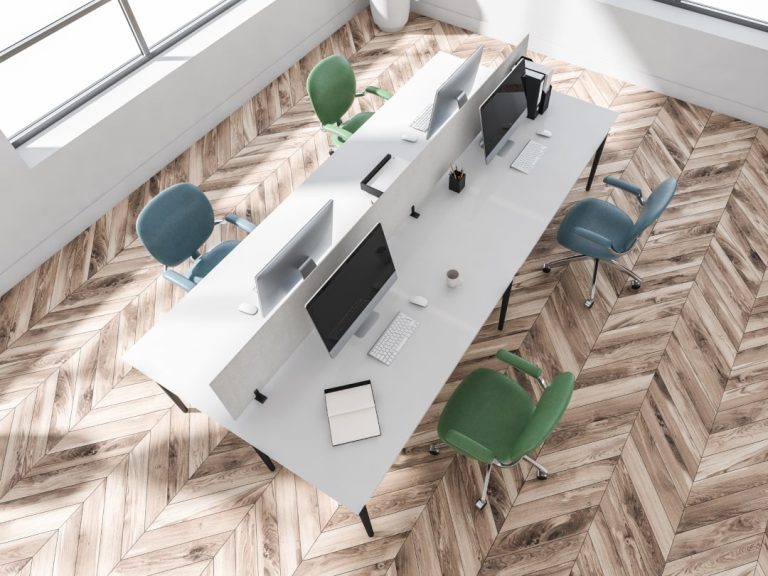 A bright office with ergonomically designed workstations, showcasing how proper ergonomic assessment contributes to a healthier work environment.