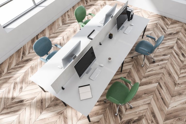 A bright office with ergonomically designed workstations, showcasing how proper ergonomic assessment contributes to a healthier work environment.