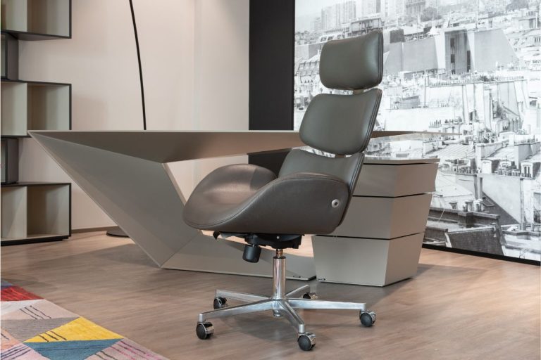 A modern office with unique decor, grey office chair and desk.