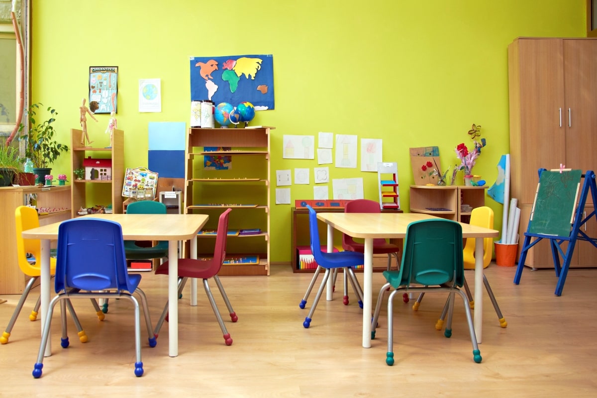 Brightly coloured chairs in a kindergarten classroom.