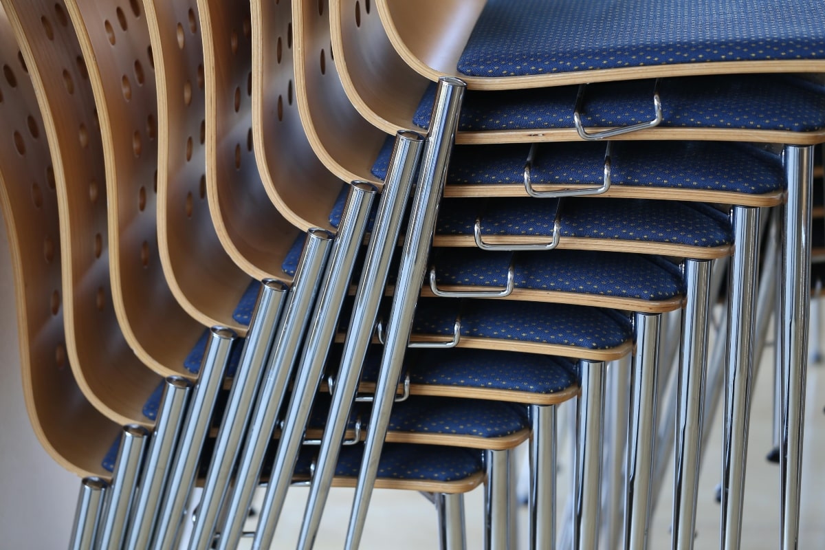 Close up of stacked classroom chairs.