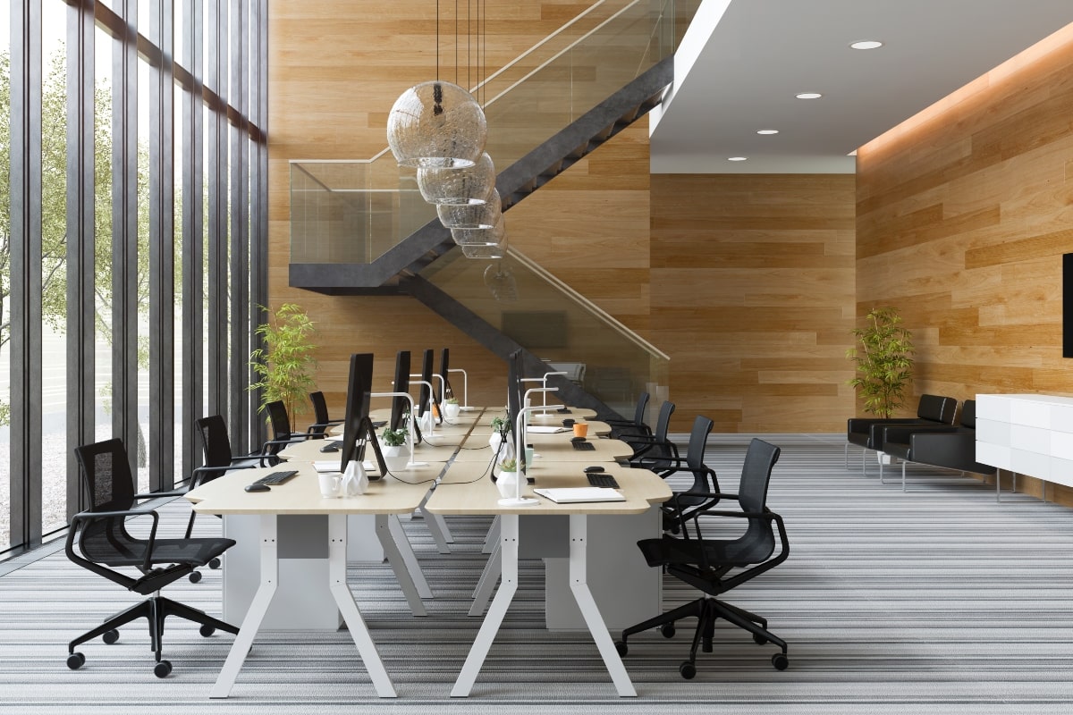 Stylish office interior filled with natural light and stylish ceiling fixtures.