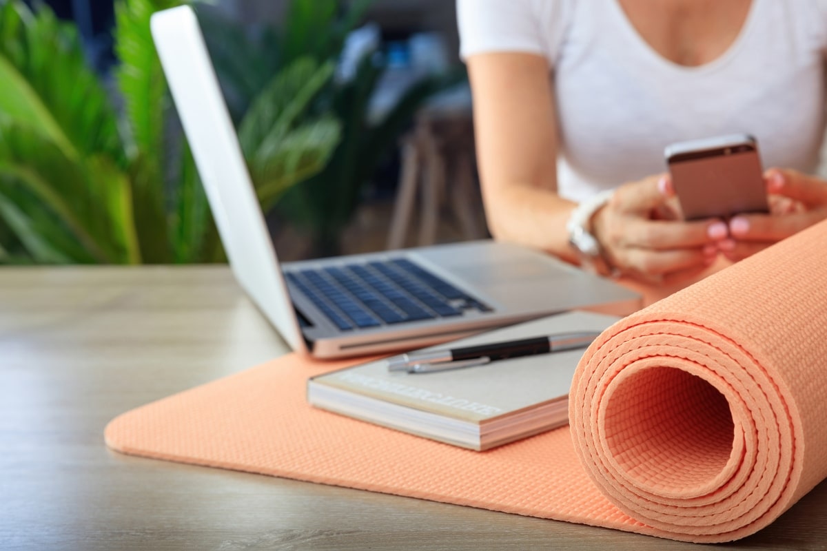 Engage in office exercises by using a yoga mat while working on your laptop. 