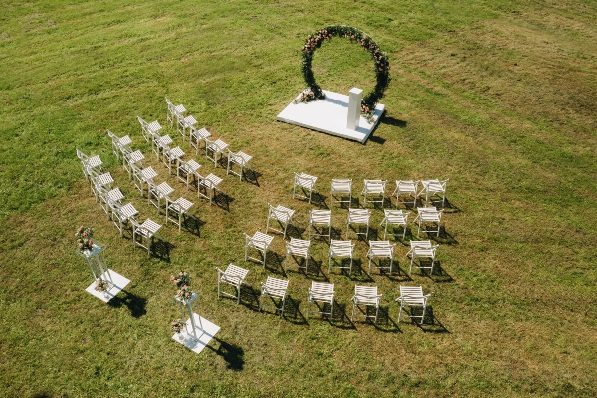 An image demonstrating the Chevron seating plan, with rows of chairs arranged in an inward-facing V shape, creating a striking visual effect with a central aisle.