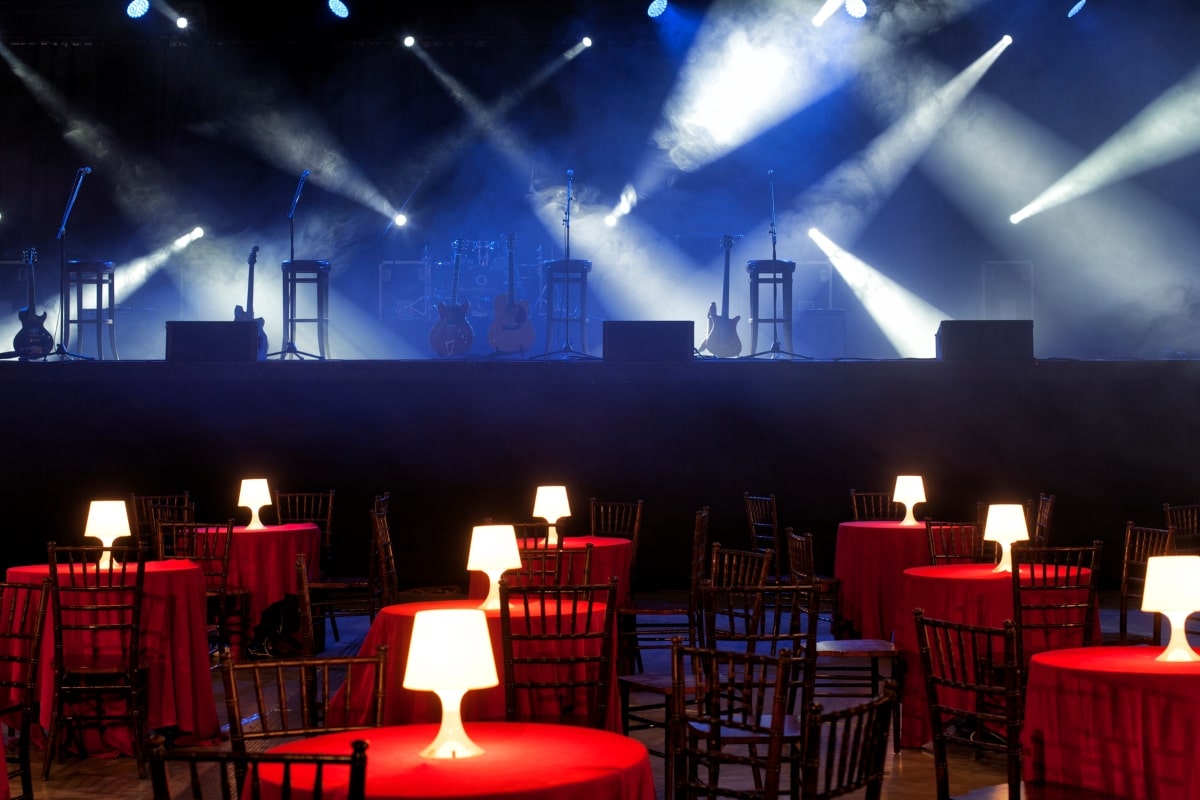 A visual featuring Cabaret-style seating plan in a vibrant night club setting.