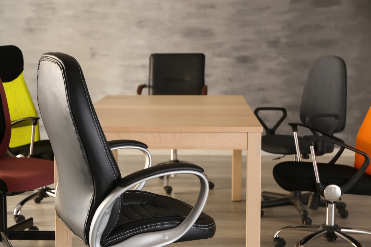 An array of office chairs, including options with leather, mesh, and textile fabrics, demonstrating the diversity of office chair fabric choices available for ergonomic workplace seating.